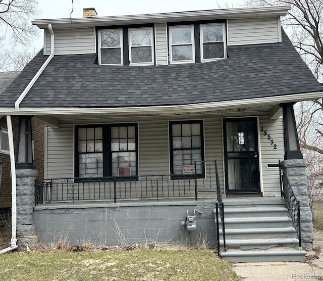 15532 Baylis St, Detroit, MI 48238 - view of front facade featuring a porch, roof with shingles, and a chimney
