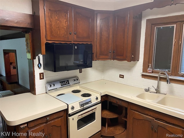 27943 Sunset Blvd W, Lathrup Village, MI 48076 - kitchen with white range with electric cooktop, black microwave, decorative backsplash, and light countertops