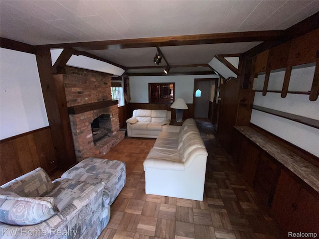 27943 Sunset Blvd W, Lathrup Village, MI 48076 - living room featuring wood walls, a wainscoted wall, a brick fireplace, and rail lighting