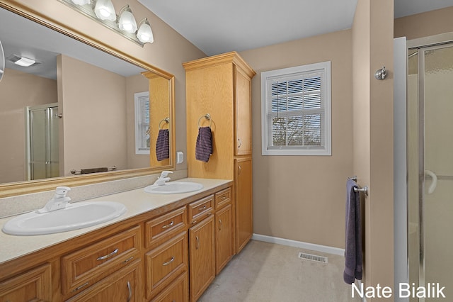 7165 Keystone Ct, Jenison, MI 49428 - full bathroom with a stall shower, double vanity, and baseboards