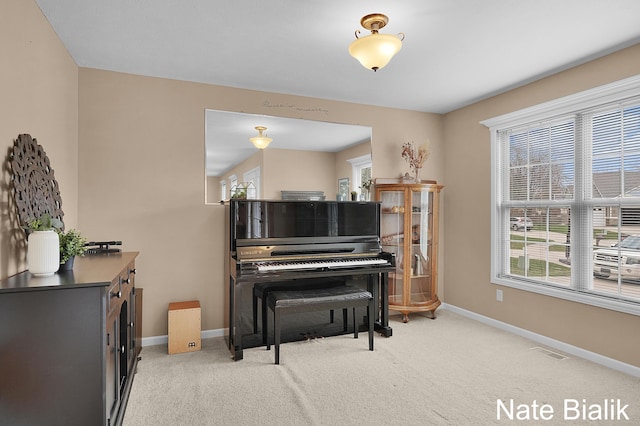 7165 Keystone Ct, Jenison, MI 49428 - living area with baseboards, light colored carpet, and healthy amount of natural light