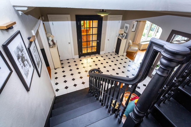 953 Berkshire Rd, Grosse Pointe Park, MI 48230 - stairs with tile patterned floors, arched walkways, and baseboards