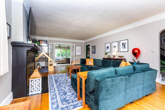 953 Berkshire Rd, Grosse Pointe Park, MI 48230 - living room featuring wood finished floors, a fireplace, crown molding, a textured ceiling, and a textured wall