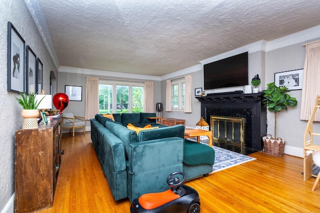 953 Berkshire Rd, Grosse Pointe Park, MI 48230 - living room featuring wood finished floors, a textured ceiling, a fireplace with flush hearth, crown molding, and baseboards