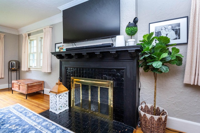 953 Berkshire Rd, Grosse Pointe Park, MI 48230 - detailed view of a fireplace with flush hearth, ornamental molding, wood finished floors, a textured wall, and baseboards