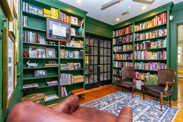 953 Berkshire Rd, Grosse Pointe Park, MI 48230 - living area featuring wood finished floors, crown molding, wall of books, a ceiling fan, and french doors