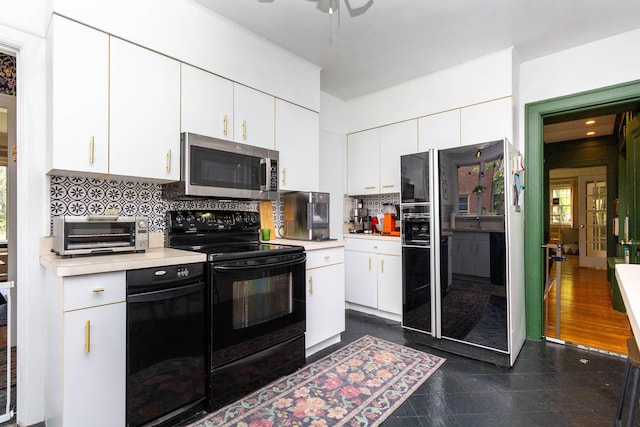 953 Berkshire Rd, Grosse Pointe Park, MI 48230 - kitchen with black appliances, light countertops, decorative backsplash, white cabinets, and granite tiled floors