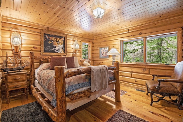 1547 N Dennis Rd, Ludington, MI 49431 - bedroom with multiple windows, hardwood / wood-style floors, and wooden ceiling