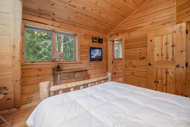 1547 N Dennis Rd, Ludington, MI 49431 - bedroom featuring multiple windows, lofted ceiling, wood ceiling, wood finished floors, and wooden walls