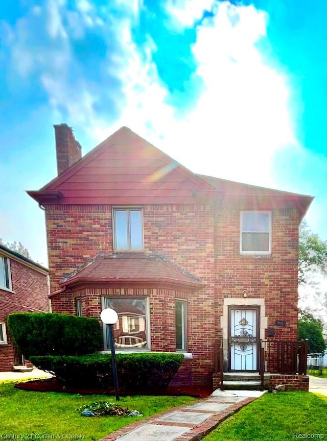 19191 Littlefield St, Detroit, MI 48235 - view of front of home with a chimney, brick siding, and a front yard