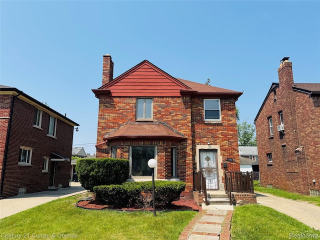 19191 Littlefield St, Detroit, MI 48235 - traditional home featuring a chimney, a front yard, and brick siding