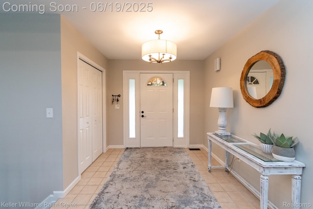 75757 Peters Dr, Bruce, MI 48065 - foyer entrance featuring light tile patterned floors and a chandelier
