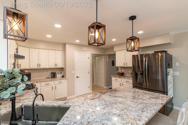 75757 Peters Dr, Bruce, MI 48065 - kitchen with backsplash, stainless steel fridge with ice dispenser, white cabinetry, light stone countertops, and recessed lighting