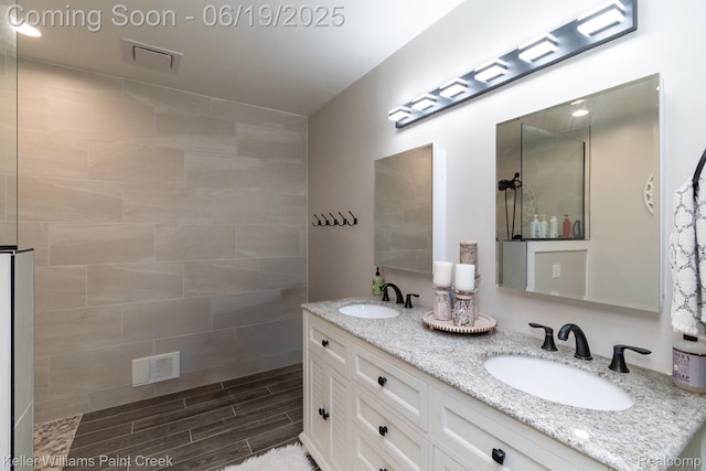 75757 Peters Dr, Bruce, MI 48065 - full bath with double vanity, a walk in shower, and wood finish floors