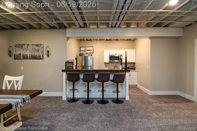 75757 Peters Dr, Bruce, MI 48065 - indoor bar featuring appliances with stainless steel finishes and dark colored carpet
