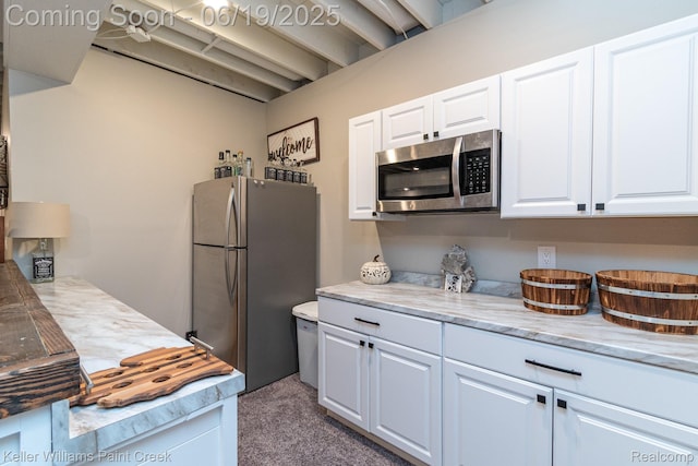 75757 Peters Dr, Bruce, MI 48065 - kitchen with stainless steel appliances, carpet floors, and white cabinetry
