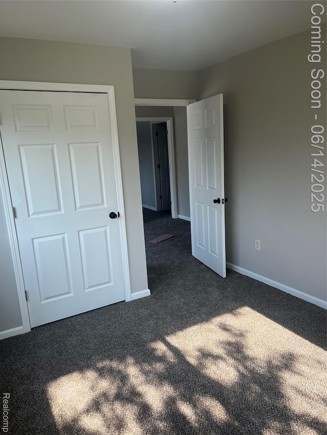 2145 Terrapin St, Wolverine Lake, MI 48390 - unfurnished bedroom featuring dark colored carpet and baseboards