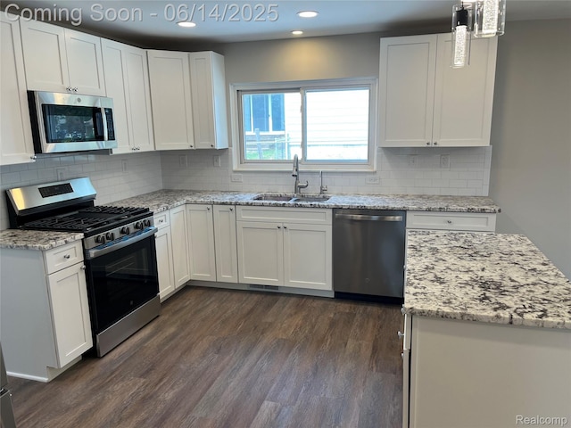 2145 Terrapin St, Wolverine Lake, MI 48390 - kitchen with appliances with stainless steel finishes, recessed lighting, dark wood-type flooring, white cabinets, and light stone counters