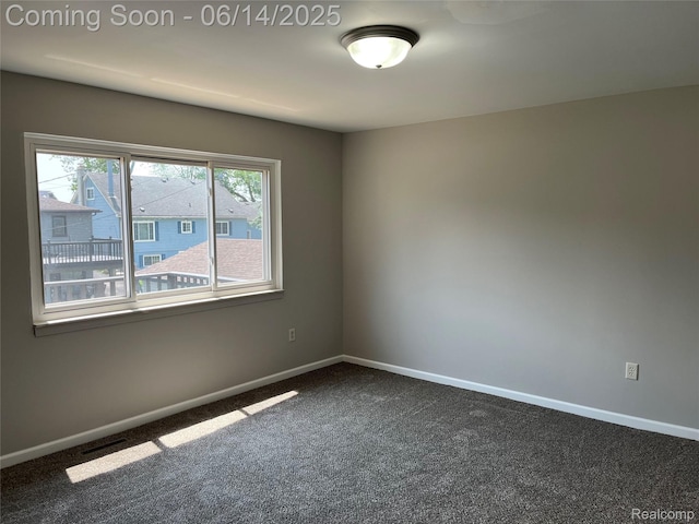 2145 Terrapin St, Wolverine Lake, MI 48390 - empty room featuring dark colored carpet and baseboards