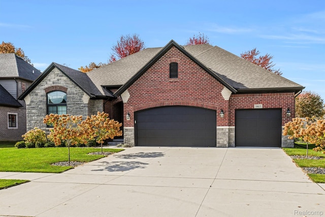 50035 Anita Way N, Macomb, MI 48044 - view of front facade with stone siding, a garage, concrete driveway, roof with shingles, and a front lawn