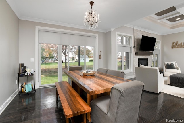 50035 Anita Way N, Macomb, MI 48044 - dining area featuring ornamental molding, dark wood-style flooring, plenty of natural light, a chandelier, and a large fireplace