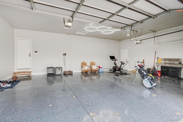 50035 Anita Way N, Macomb, MI 48044 - garage featuring a garage door opener and baseboards