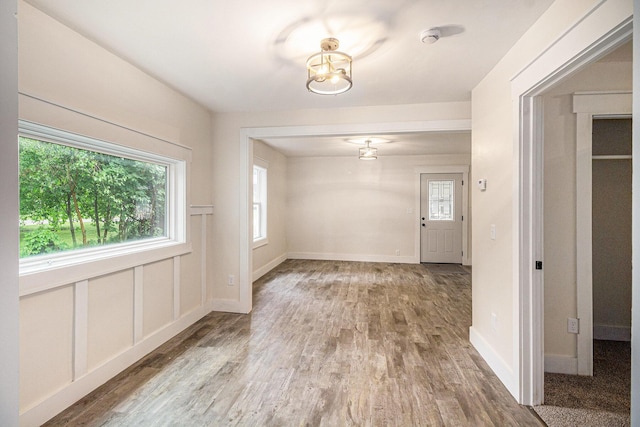 145 Sycamore St, Jackson, MI 49202 - unfurnished dining area featuring wood finished floors, plenty of natural light, and a chandelier