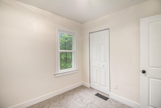 145 Sycamore St, Jackson, MI 49202 - unfurnished bedroom with light colored carpet and a closet