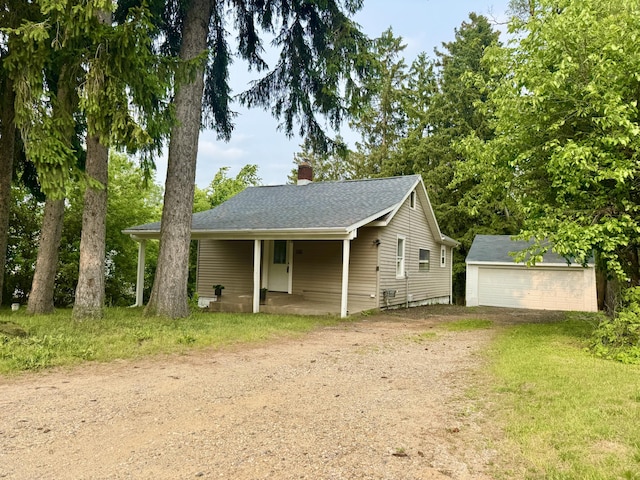 145 Sycamore St, Jackson, MI 49202 - view of front facade featuring driveway, a chimney, and an outdoor structure