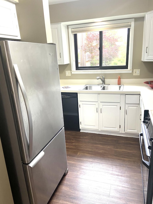 2165 Pauline Ct, Ann Arbor, MI 48103 - kitchen featuring freestanding refrigerator, a sink, black dishwasher, stove, and white cabinets