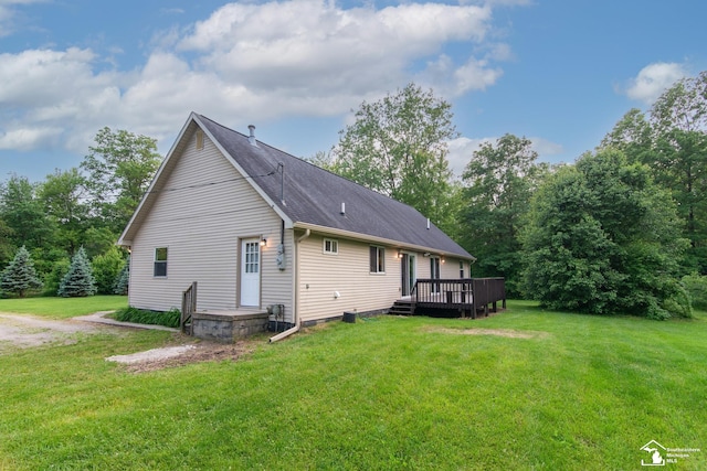 45510 Arkona Rd, Belleville, MI 48111 - rear view of house featuring a yard and a deck