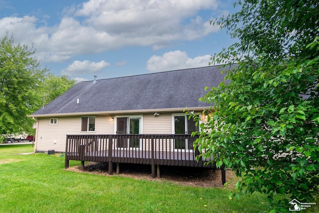 45510 Arkona Rd, Belleville, MI 48111 - back of house featuring a lawn, a wooden deck, and a shingled roof