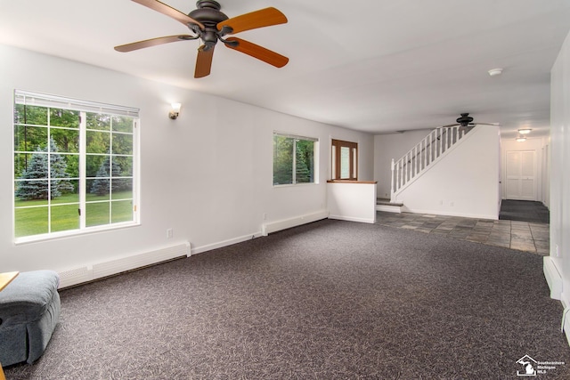 45510 Arkona Rd, Belleville, MI 48111 - unfurnished living room with ceiling fan, a baseboard heating unit, dark carpet, and plenty of natural light