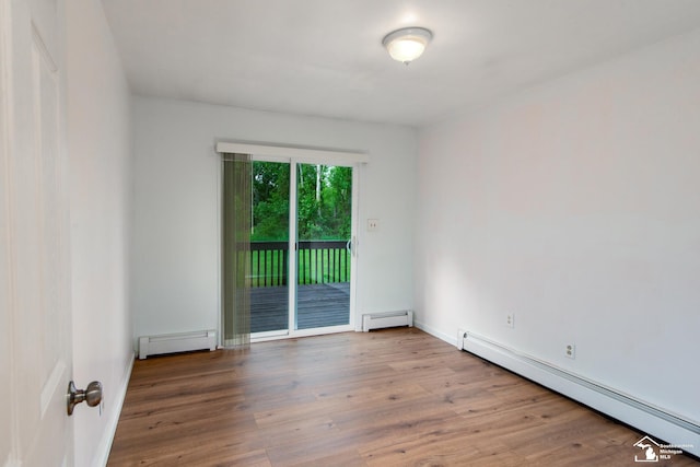 45510 Arkona Rd, Belleville, MI 48111 - unfurnished room with a baseboard radiator, wood finished floors, and baseboards