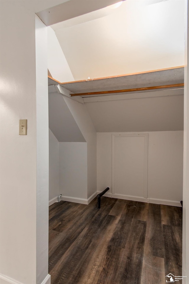45510 Arkona Rd, Belleville, MI 48111 - additional living space with dark wood-style floors, vaulted ceiling, and baseboards