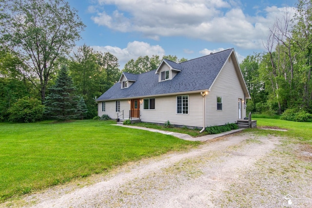 45510 Arkona Rd, Belleville, MI 48111 - new england style home featuring a front lawn, driveway, and a shingled roof