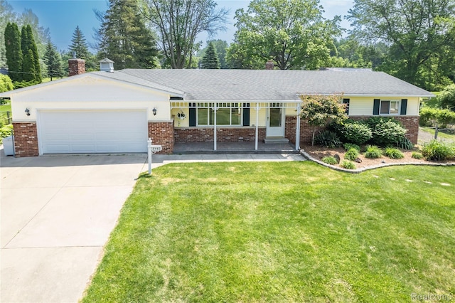 3460 N Gale Rd, Davison, MI 48423 - ranch-style house with a chimney, brick siding, an attached garage, concrete driveway, and a front lawn