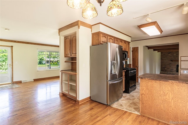 3460 N Gale Rd, Davison, MI 48423 - kitchen with appliances with stainless steel finishes, light wood-style flooring, track lighting, crown molding, and baseboards