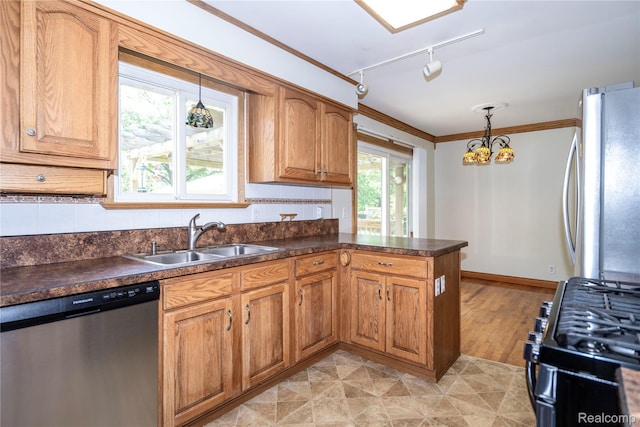 3460 N Gale Rd, Davison, MI 48423 - kitchen featuring appliances with stainless steel finishes, a sink, rail lighting, dark countertops, and ornamental molding