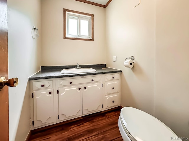3460 N Gale Rd, Davison, MI 48423 - bathroom with toilet, vanity, wood finished floors, and crown molding