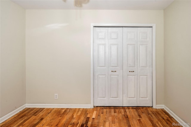3460 N Gale Rd, Davison, MI 48423 - unfurnished bedroom with wood finished floors, baseboards, and a closet