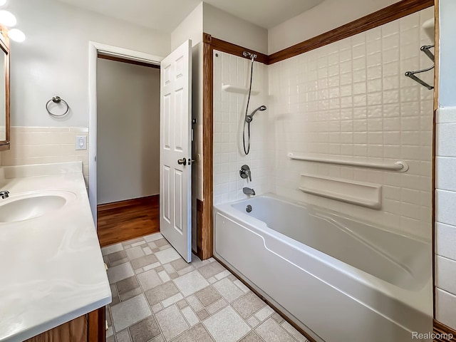 3460 N Gale Rd, Davison, MI 48423 - bathroom featuring double vanity, shower / bathtub combination, and tile walls