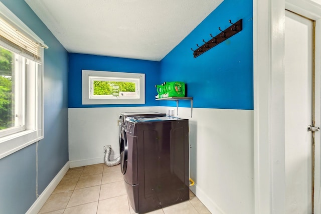 3307 Brookfield Ave, Kalamazoo, MI 49048 - washroom featuring washing machine and clothes dryer, tile patterned floors, baseboards, and a textured ceiling