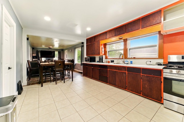 3307 Brookfield Ave, Kalamazoo, MI 49048 - kitchen featuring stainless steel appliances, a sink, light countertops, reddish brown cabinets, and recessed lighting