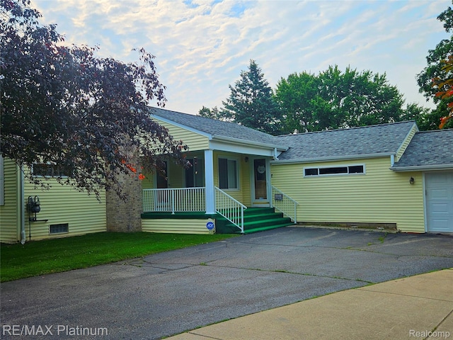 7257 Miller Rd, Swartz Creek, MI 48473 - view of front of house featuring covered porch, roof with shingles, and driveway