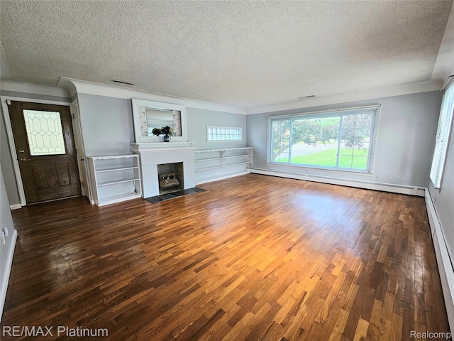 7257 Miller Rd, Swartz Creek, MI 48473 - unfurnished living room with a textured ceiling, wood finished floors, a fireplace with flush hearth, baseboard heating, and ornamental molding