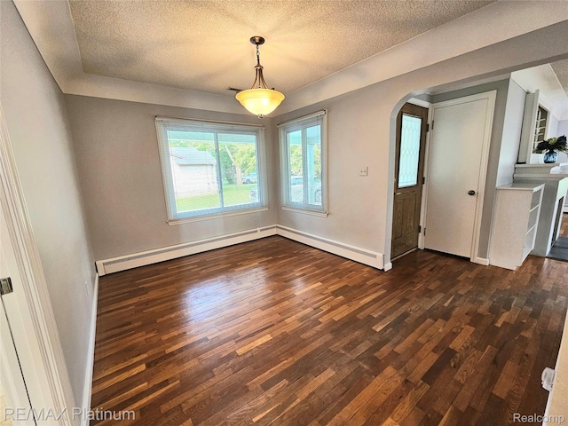 7257 Miller Rd, Swartz Creek, MI 48473 - empty room featuring dark wood-type flooring, arched walkways, a textured ceiling, baseboard heating, and baseboards
