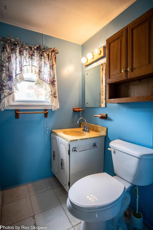 3118 W 104th St, Grant, MI 49327 - half bath featuring vanity, toilet, tile patterned floors, and a textured ceiling