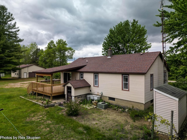 3118 W 104th St, Grant, MI 49327 - rear view of house featuring a wooden deck, a shingled roof, a yard, cooling unit, and a chimney