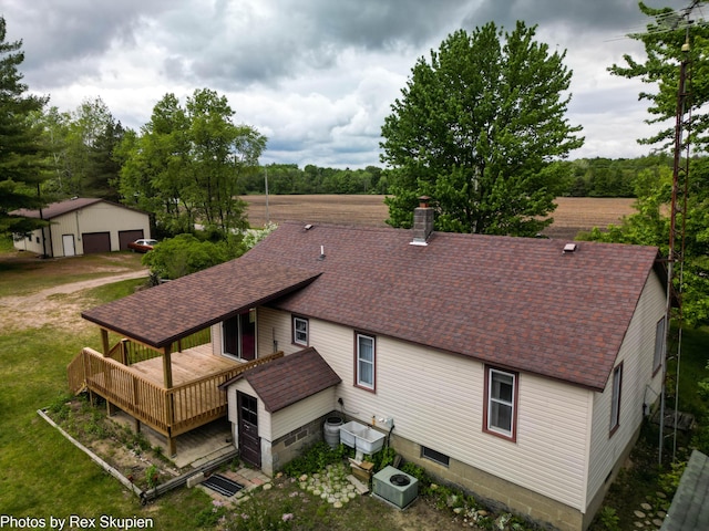 3118 W 104th St, Grant, MI 49327 - rear view of house featuring an outbuilding, a wooden deck, roof with shingles, and a detached garage